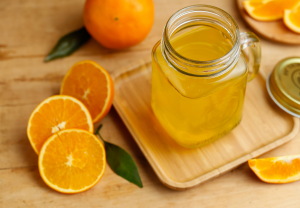 Orange juice and oranges on retro wooden desk